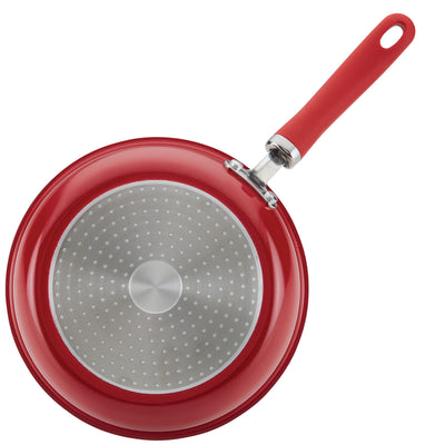 Red frying pan with a non-stick surface and a red handle.