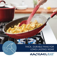 The Cook + Create Nonstick Frying Pan on the stove is a high-performance red pan crafted with thicker gauge aluminum, making it perfect for pasta and advertised for its thick and durable design.