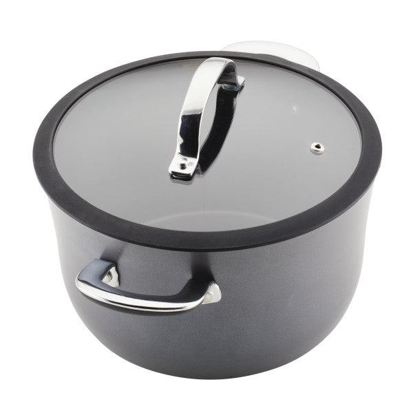 The Cook + Create Hard Anodized Nonstick Cookware Set includes a sleek black cooking pot made from hard-anodized aluminum, featuring a tempered glass lid and sturdy metal handles for easy handling.
