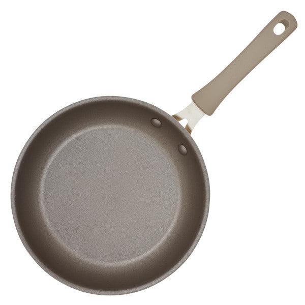 The Cook + Create Nonstick Frying Pan features a high-performance surface and a beige handle, crafted from thicker gauge aluminum, as seen from above.