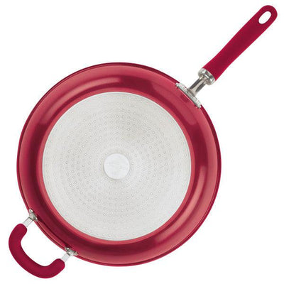 Red non-stick frying pan with dual handles, viewed from above.