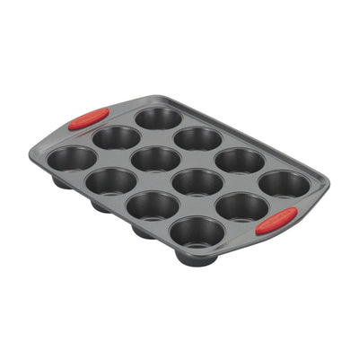 A 12-cup nonstick muffin pan with red silicone grips on the handles.