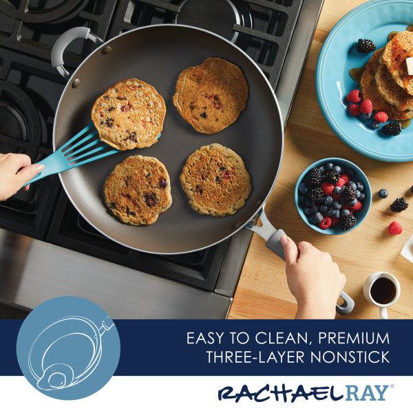 A high-performance Cook + Create Nonstick Frying Pan sits on the stove, perfectly cooking fluffy pancakes. Nearby, a bowl brims with fresh berries, and a steaming cup of coffee completes the scene.