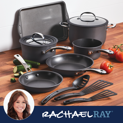 A set of nonstick cookware and utensils displayed on a wooden surface.