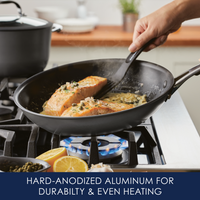 Cooking salmon fillets in a frying pan on a gas stove.