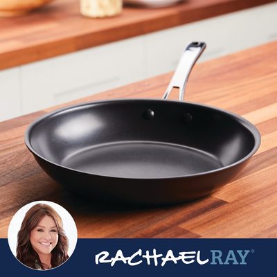 Black frying pan on wooden countertop, Rachael Ray logo in corner.