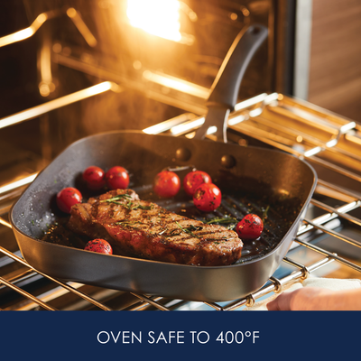 Steak and tomatoes in frying pan inside an oven. Text: "Oven Safe to 400°F".