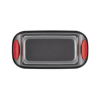 Rectangular baking tray with red silicone grips on the sides.