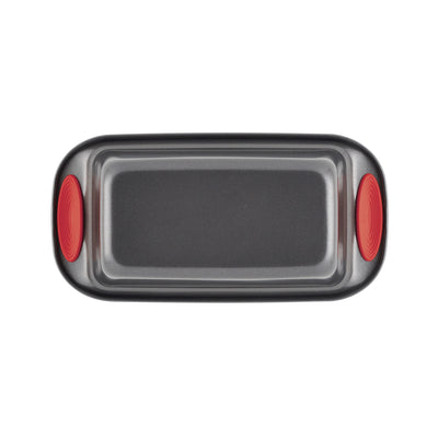 Rectangular baking tray with red silicone grips on the sides.