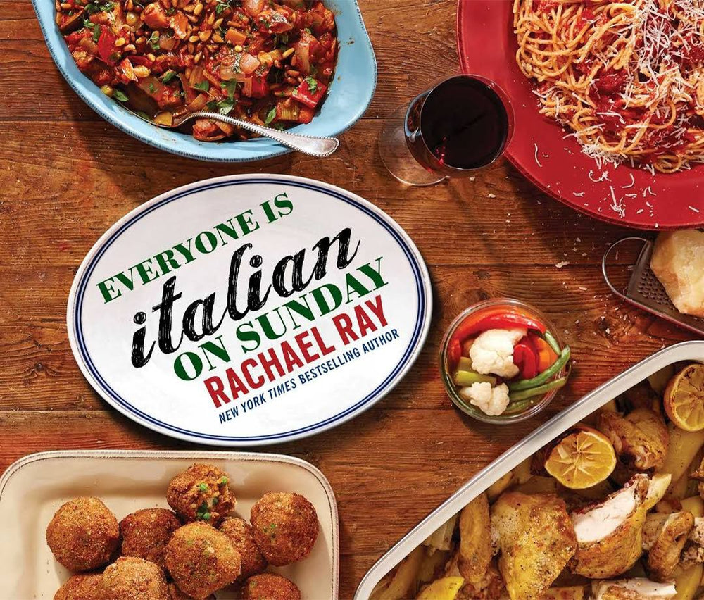 Cookbook "Everyone Is Italian on Sunday" surrounded by Italian dishes.