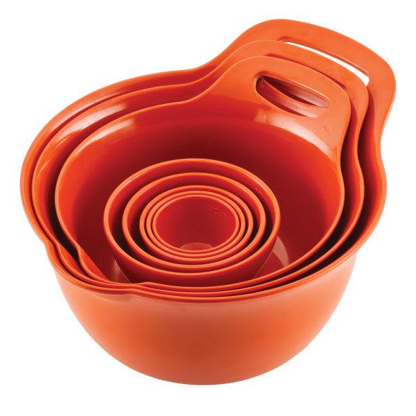 Stacked orange measuring cups and bowls with handles.