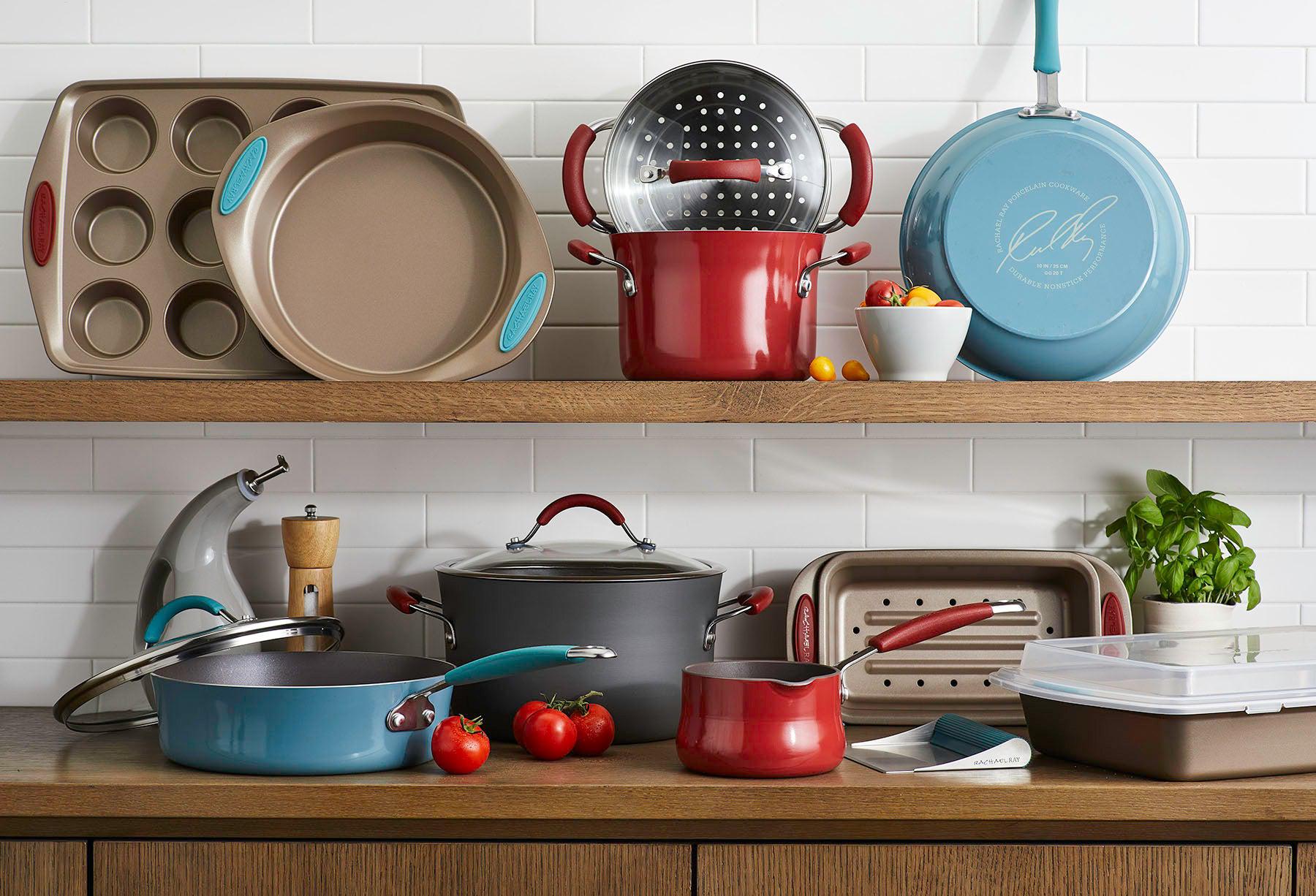 A collection of colorful cookware displayed on wooden kitchen shelves.
