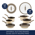 Two silicone-rimmed glass lids beside a beige cookware set with pans.