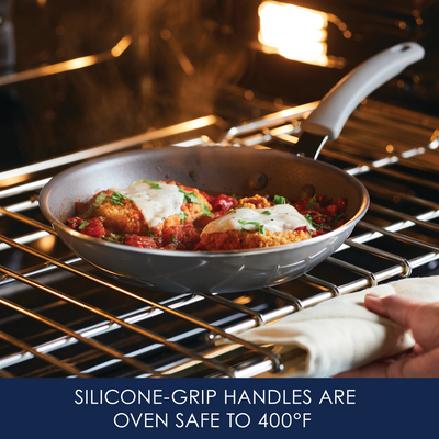 Frying pan with food in oven; silicone grip handles indicated.