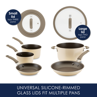 Cookware set with two silicone-rimmed glass lids and various pots and pans.