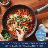 Skillet with eggs poached in a tomato sauce; hand adding herbs.