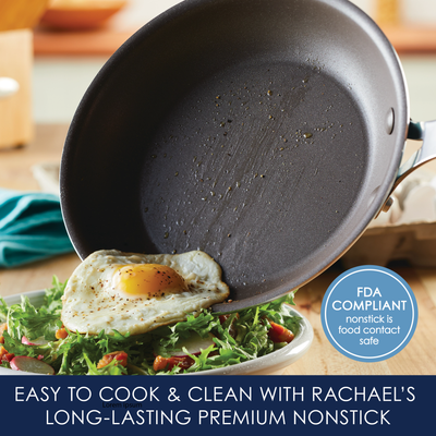 Nonstick pan with fried egg and salad, labeled FDA compliant.