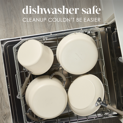 Open dishwasher with four cream-colored pots inside.