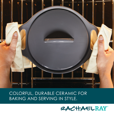 Person placing a ceramic dish into an oven on a rack.