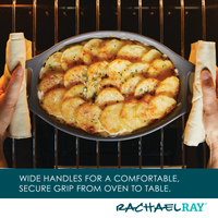 Person holding a dish of baked potato slices in an oven.
