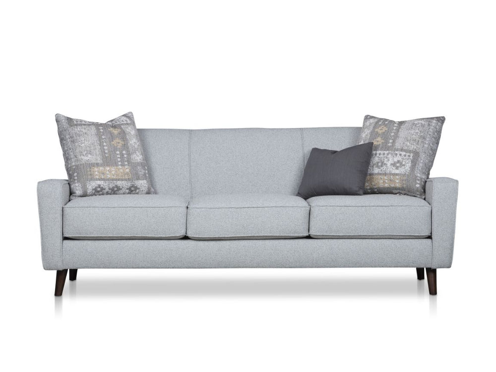 A light gray sofa with three cushions and patterned throw pillows.