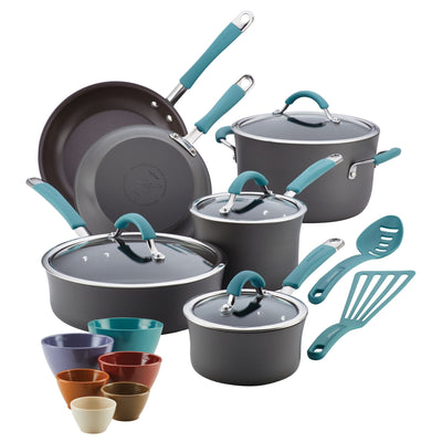 Cookware set with pots, pans, lids, and colorful bowls and utensils.