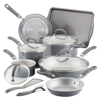 A set of nonstick cookware and utensils with lids on display.