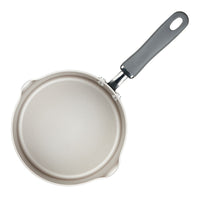 Top view of a frying pan with a black handle on a white background.