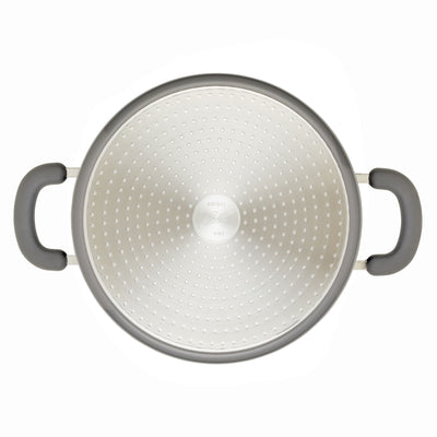 Metal colander with two black handles viewed from above.