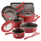 Red nonstick cookware set with pans, pots, lids, and a spatula.