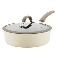 Beige saucepan with a glass lid and grey handle.