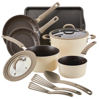 Beige cookware set with pots, pans, lids, utensils, and a baking sheet.