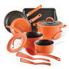 The Cook + Create Nonstick Cookware Sets in a vibrant orange color include pots, pans, and utensils, along with tempered glass lids for easy monitoring. With enhanced scratch resistance, this collection promises lasting durability and performance in your kitchen.