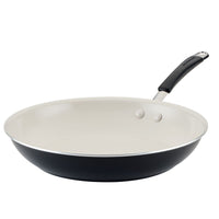 Black frying pan with a white interior and a handle.