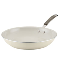 A beige frying pan with a gray handle against a white background.