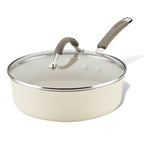 Cream-colored saucepan with lid and gray handle on a white background.