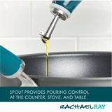 Oil bottle spout pouring into a cooking pan against a white background.