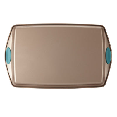 Rectangular non-stick baking tray with teal grip handles.