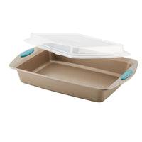 Rectangular baking pan with teal handles and a transparent plastic lid.