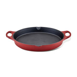 The 14-Inch NITRO Cast Iron Skillet is a vibrant red piece featuring two sturdy handles. Oven safe and induction ready, it offers style and versatility to your kitchen, set against a crisp white background.