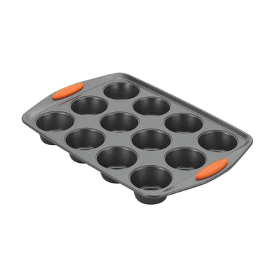 A 12-cup muffin tin with orange handles.