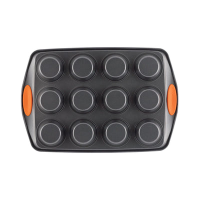 Muffin pan with twelve cups and orange handles.