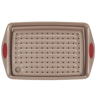 A perforated baking sheet with handles and a drain spout.