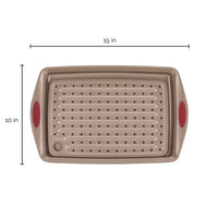 Rectangular baking pan with red handles, 15x10 inches, perforated surface.