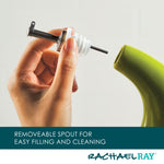 Hand holding a removable spout next to a green container.