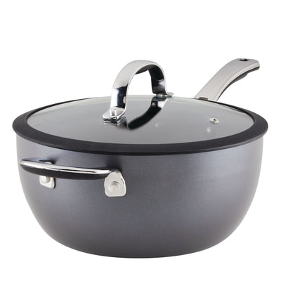 Gray saucepan with a glass lid and metal handle on a white background.