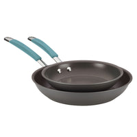 Two non-stick frying pans with light blue handles stacked together.