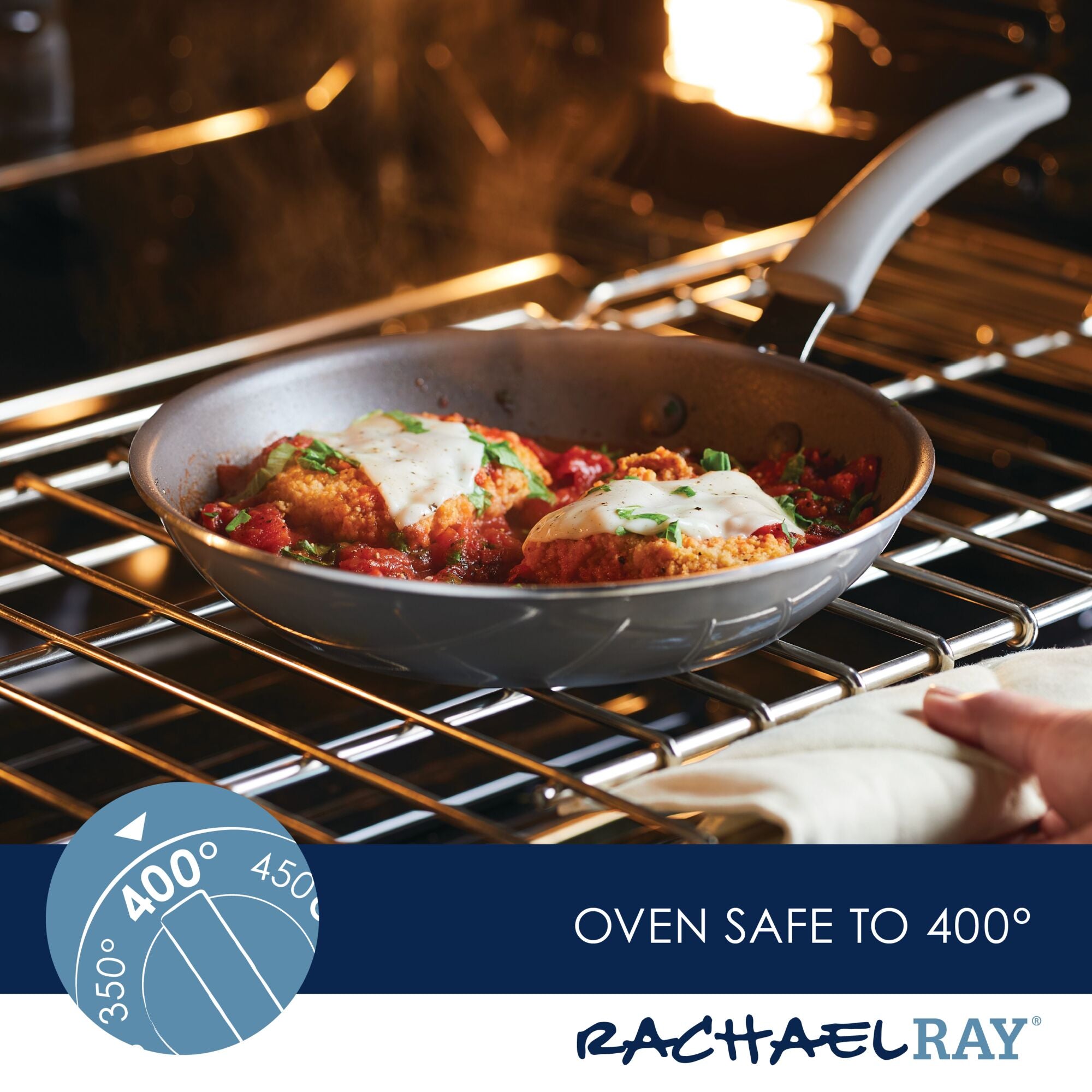 A hand firmly grips the handle of a skillet from the 6-Piece Cook + Create Nonstick Cookware Set, safely placed in the oven at 400°F with food inside.