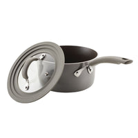 Partially open gray saucepan from the 6-Piece Cook + Create Nonstick Cookware Set, made from durable aluminum with a glass lid, on a white background.