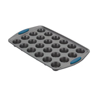 Nonstick 24-cup mini muffin pan with blue silicone grips.